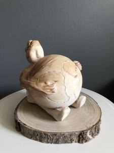 Ceramiczna rzeźba człowieka obejmującego kulę ziemską